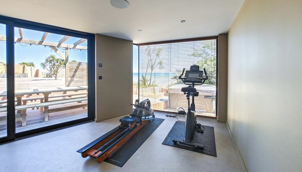 Indoor gym with exercise bike and rowing machine